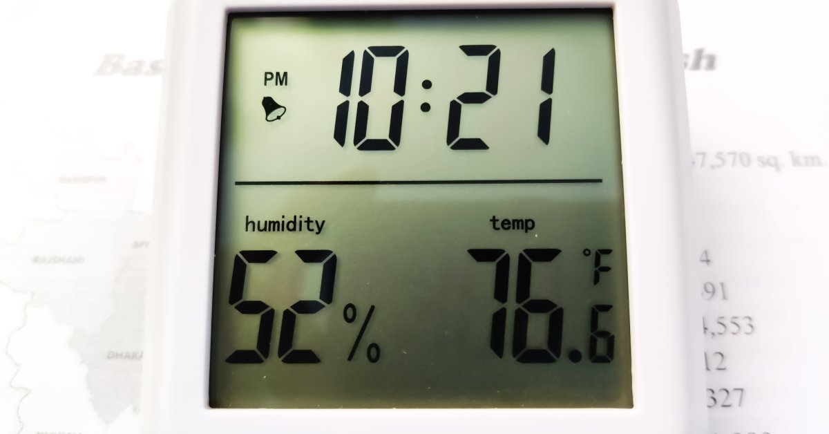 A white device digitally displays the time at 10:21, the temperature at 76.6 degrees Fahrenheit, and the humidity at 52 percent.