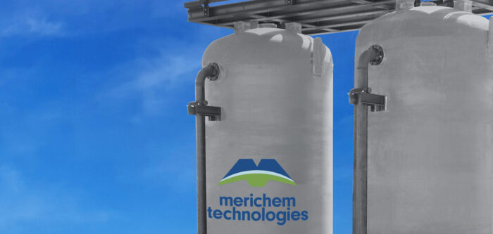 top of vertical lead/lag vessels with platform and Merichem Technologies blue and green logo against blue sky